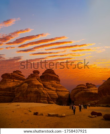 Tourists at Mada'in Saleh archaeological sites near Al Ula at Sunset, Saudi Arabia Royalty-Free Stock Photo #1758437921