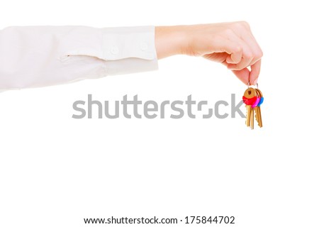 Female hand real estate agent holding set of keys to new house or car. Property business and accommodation or home buying ownership concept, isolated on white background