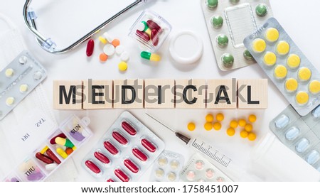 medicare word written onmedical word written on wood block. medicare text on table, concept. Medicine, pills and stethoscope wood block. medicare text on table, concept.