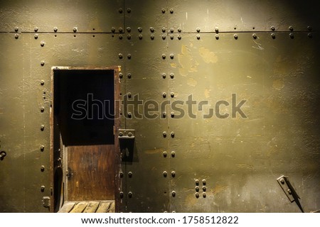 Dark metal wall and door in a war bunker Royalty-Free Stock Photo #1758512822