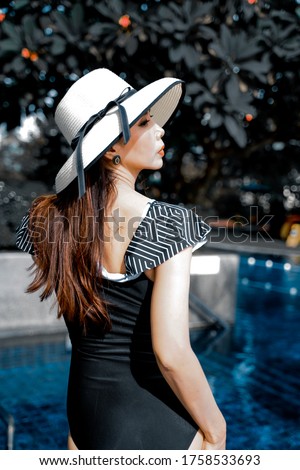 Side view​ of​ a woman in a black swimsuit 