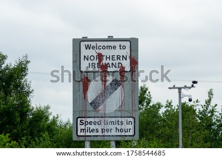 Welcome to Northern Ireland sign  with brown paint stains on the M1 A1 motorway Dublin Belfast on the border Republic of Ireland and Northern Ireland UK