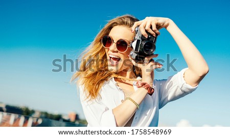 Young traveler is being happy and taking pictures