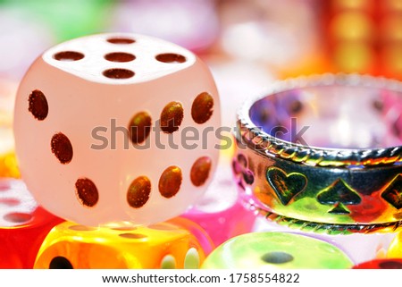Colorful game dice with yellow, green, blue and purple dice                                                                                             