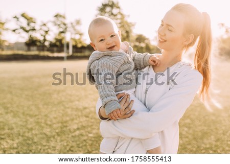 Happy family in the fresh air. mom laughs and plays with her little child in the summer outdoors