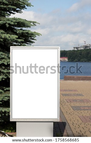Blank street billboard stand mockup with lake and building view. Empty billboard with copyspace.