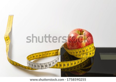 Diet plan, menu or program, tape measure, diet food of fresh fruits on white background, weight loss and detox concept, top view. weight loss concept. Apple and measuring tape. Diet.