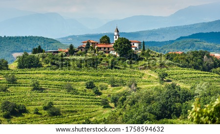 View of famous wine region Goriska Brda hills in Slovenia. Panoramic photo of villages of Gorica Hills with vineyards and grapevine covering hills. Agricultural wine region of Slovenia. Royalty-Free Stock Photo #1758594632
