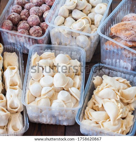 Assortment of Pocket items. Semifinished meatballs, dumplings, pierogi in plastic containers. Royalty-Free Stock Photo #1758620867