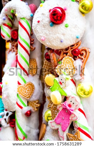 Vertical close-up picture of colorful christmas decorations with candies on christmas market in capital of xmas Strasbourg, France. Travel tourism destination.