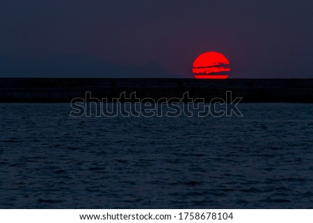 big sun set in the middle of the sea