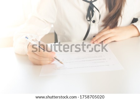 Girl fills an employment contract in the office