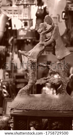 a sculpture of an antique shop. The dance of a man and a woman.           