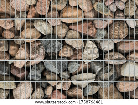 Background of stones and mesh. Texture stone and metal mesh