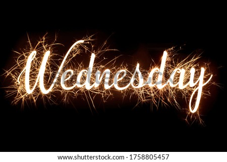 Wednesday banner text in dazzling sparkler effect on isolated black background