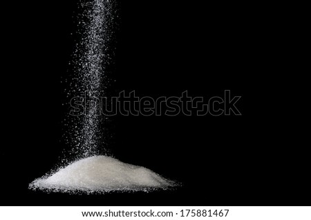 sugar sprinkle on a pile with black background Royalty-Free Stock Photo #175881467