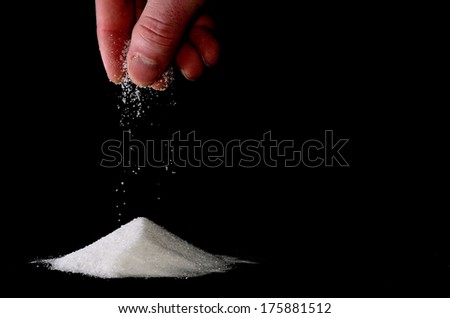 sugar trickles of a hand on a pile Royalty-Free Stock Photo #175881512