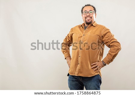 expression and people concept - Positive and happy man with funny face over gray background. Adult over 40 years of age.
