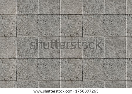 Coating with modern textured paving tiles of square shape. Royalty-Free Stock Photo #1758897263