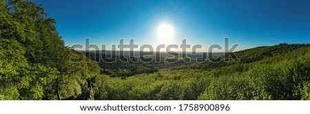 Trail runner stands on a rock in the mountains. Nature Panorama