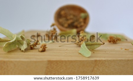 dried linden blossom and leaf on wooden background