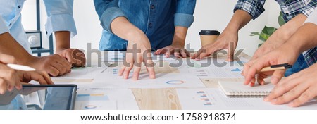 Young Asian business financial team work together in project brainstorm meeting. Cooperate teamwork, strategy planning, small business startup company, or office coworker concept. Banner size Royalty-Free Stock Photo #1758918374