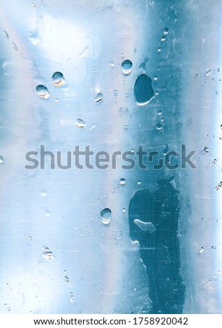 Holographic abstract background. Wet glass. Pastel blue pink surface with water drops.