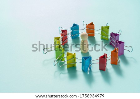 Multicolored paper clips on blue background.