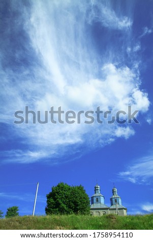 Church on a hill on the outskirts of the village. Christian temple landscape in Russia. Stock photo background