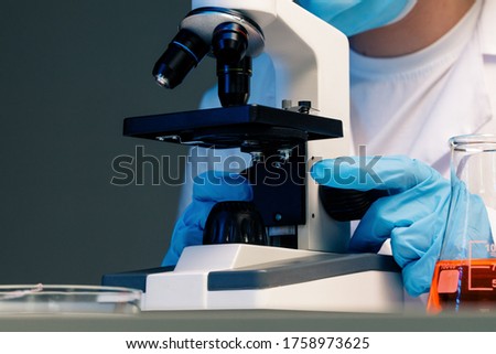 Close up photo of woman scientist working with microscope