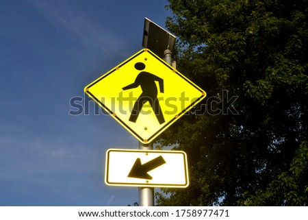 A Yellow Pedestrian Crosswalk Sign