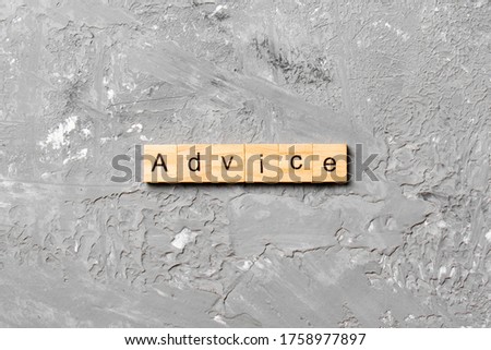 Advice word written on wood block. Advice text on table, concept.