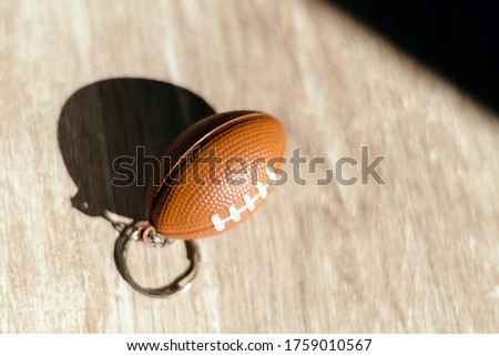 american football  keychain in a table 
