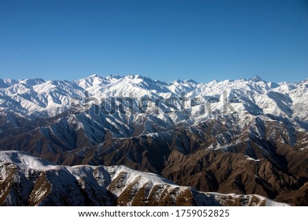 Aerial photograph of the snow covered Hindu Kush Mountain range on a cold and crisp winter morning between Pakistan and Afghanistan