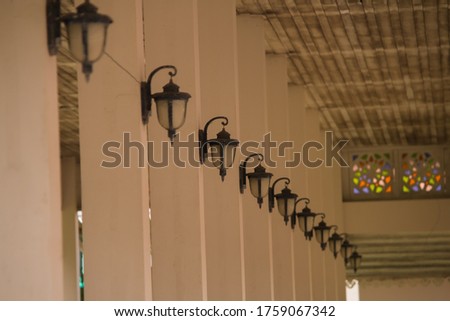 Many lamps Decorated in pillars Inside the old style vintage building. The picture is only partially clear.