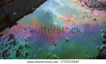multicolored background, gasoline stains, rainbow streaks, abstract texture, wet asphalt picture, vertical fluid streams.