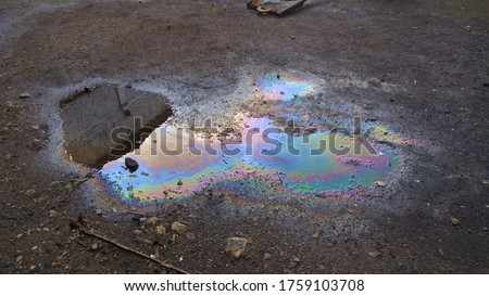 multicolored background, gasoline stains, rainbow streaks, abstract texture, wet asphalt picture, vertical fluid streams.