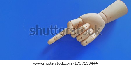 wooden​ hand​ displaying​ number​ one​ sign