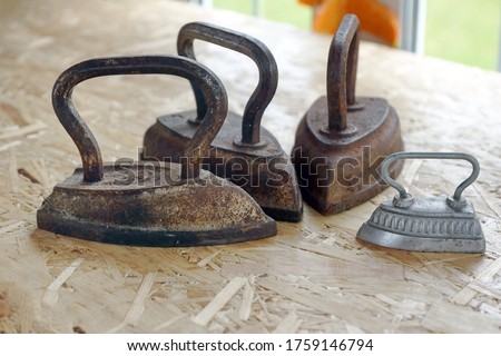 Set of old vintage cast iron and steel irons                                  Royalty-Free Stock Photo #1759146794