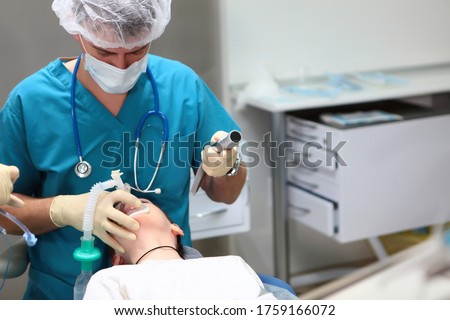 The child is placed under anesthesia before the operation. Introduction of a breathing tube into the trachea. Concept of health care and life saving. Copy space. Royalty-Free Stock Photo #1759166072