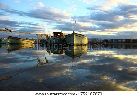 Reflection of boats in a small harbour 