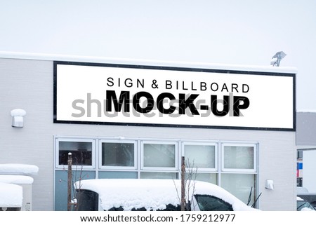 Mock up perspective blank billboard with clipping path on panel of high building and spotlight, snow covered car,  Empty space for insert advertising graphic design, outdoors for public advertisement