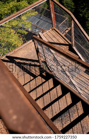 The stairs are made of metal with rust