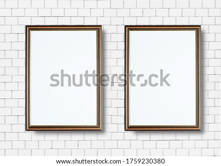 Old picture wooden frame on white brick wall in vintage room.