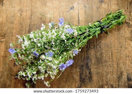 Bouquet of wildflowers on an old wooden background