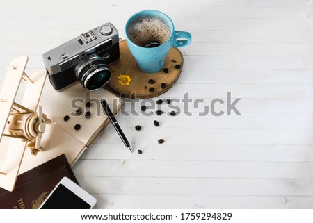 Coffee cup, camera, notebooks, Passport, Plane model,  Concept preparing for travel,reservation ticket 