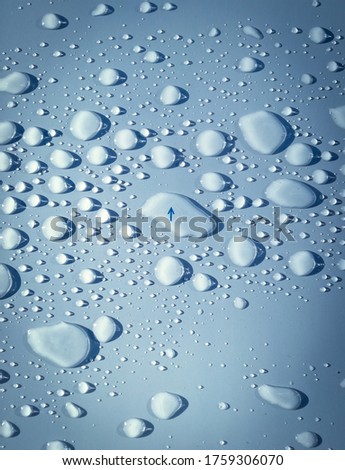 Water drops on the surface and an arrow