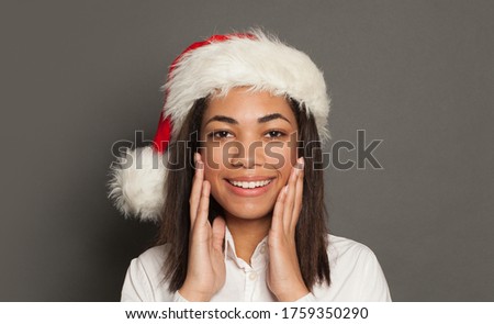 Happy smiling black woman Santa on gray background