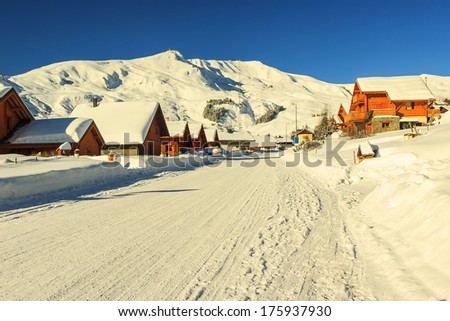 Snowy road and village,La Toussuire,France,Europe Royalty-Free Stock Photo #175937930