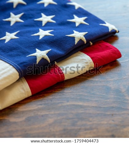 USA  flag folded on wooden table background. American flag closeup view, copy space. Memorial day and 4th of July, Independence day concept